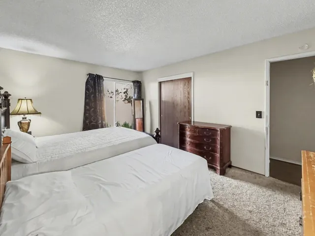 a bedroom with a bed and a television