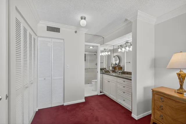 a bedroom with a bed and a dresser next to a window