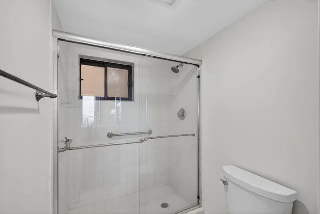 a bathroom with a toilet and a shower