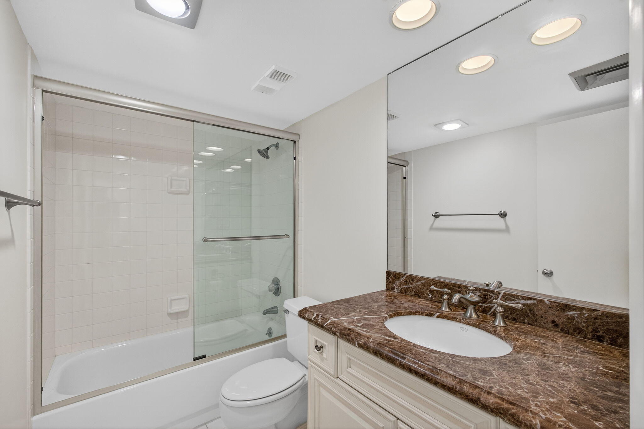100 Ocean Trail Way, Unit 305 Jupiter, FL 33477 - Photo 26 of 90 a bathroom with a granite countertop sink a toilet a mirror and shower