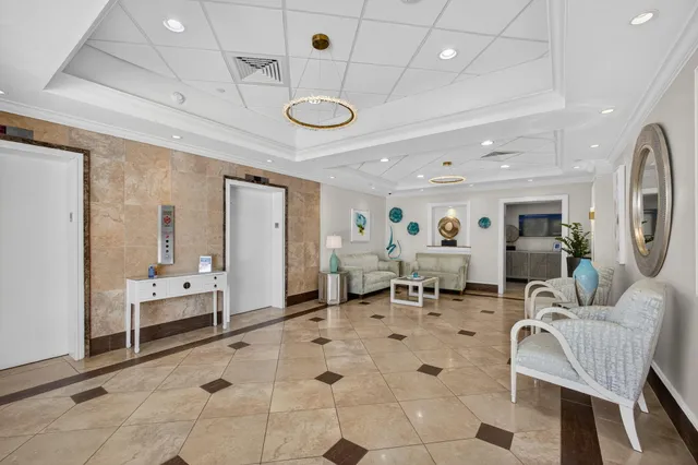 a front view of multi story residential apartment building with yard and outdoor seating