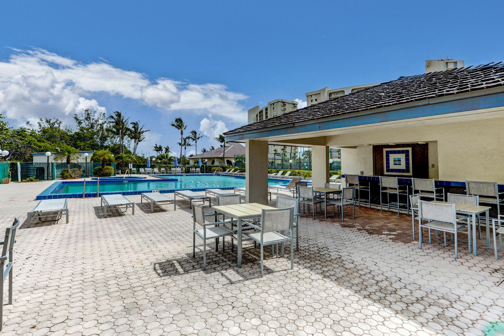 100 Ocean Trail Way, Unit 305 Jupiter, FL 33477 - Photo 71 of 90 a view of a patio with dining table and chairs with a patio