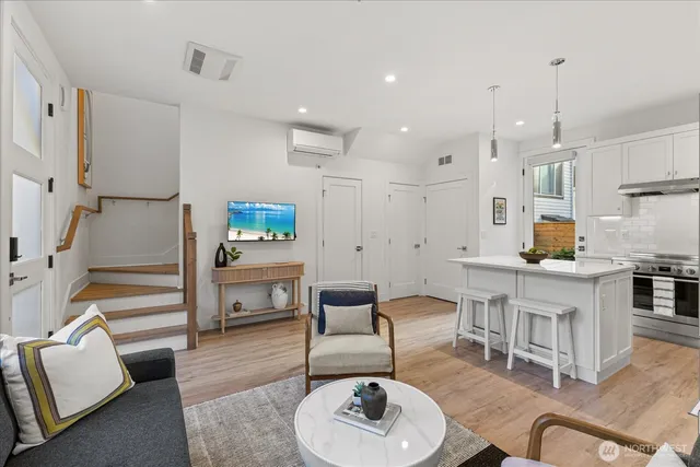 a living room with furniture and a wooden floor