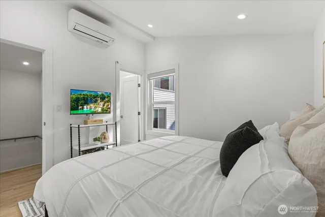 a bedroom with a bed and a flat screen tv