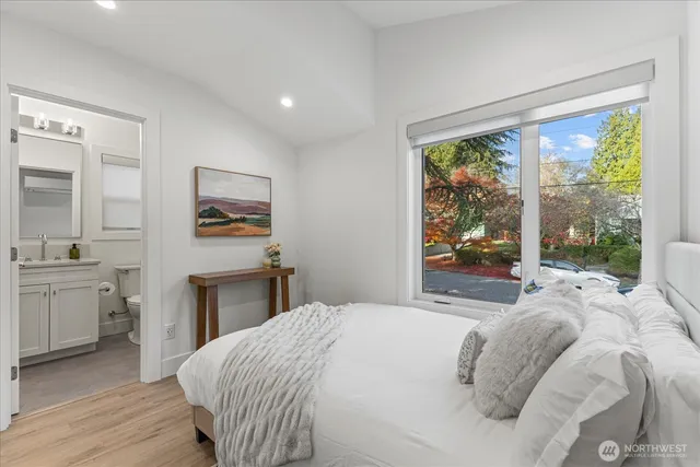 a bedroom with a bed and a large window