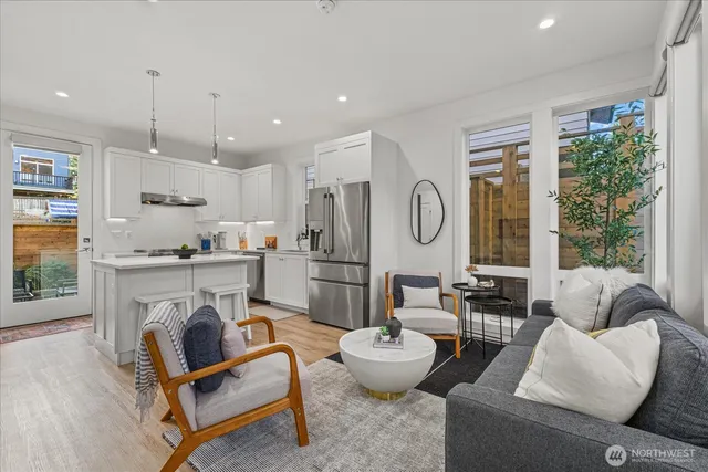a living room with fireplace furniture and a wooden floor