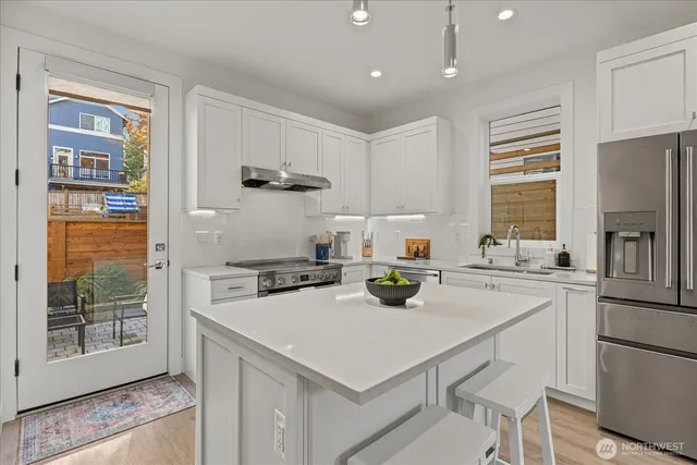 a kitchen with a stove a refrigerator and a sink