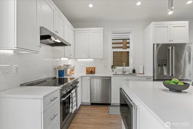 a kitchen with a sink a stove and cabinets