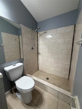 a white toilet and shower