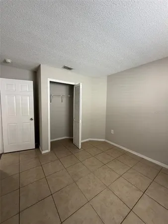 an empty room with a bench and cabinet