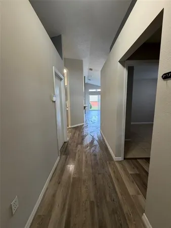 a view of hallway with wooden floor