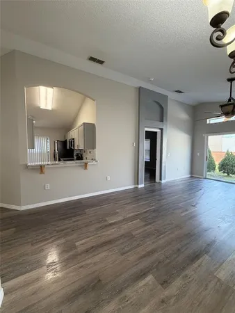 a view of a kitchen with wooden floor and a sink