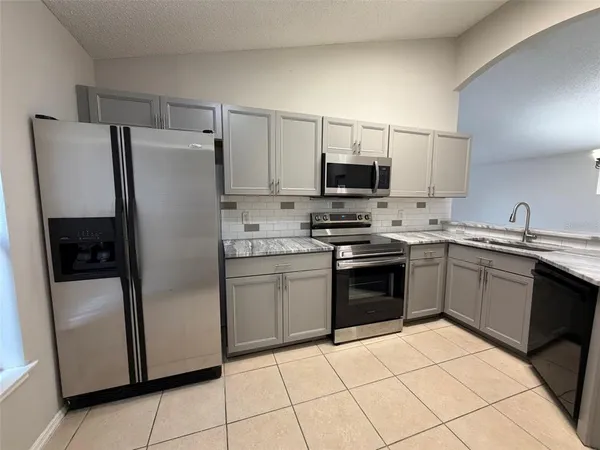 a kitchen with a refrigerator sink and microwave