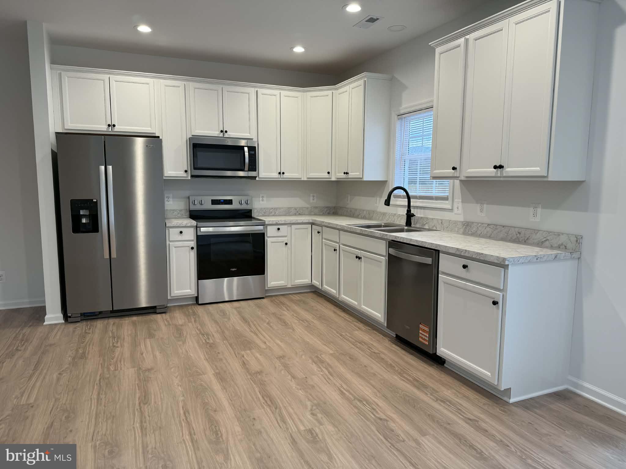 118 Windsor Knit Road Edinburg, VA 22824 - Photo 15 of 34 a kitchen with granite countertop a refrigerator sink and white cabinets