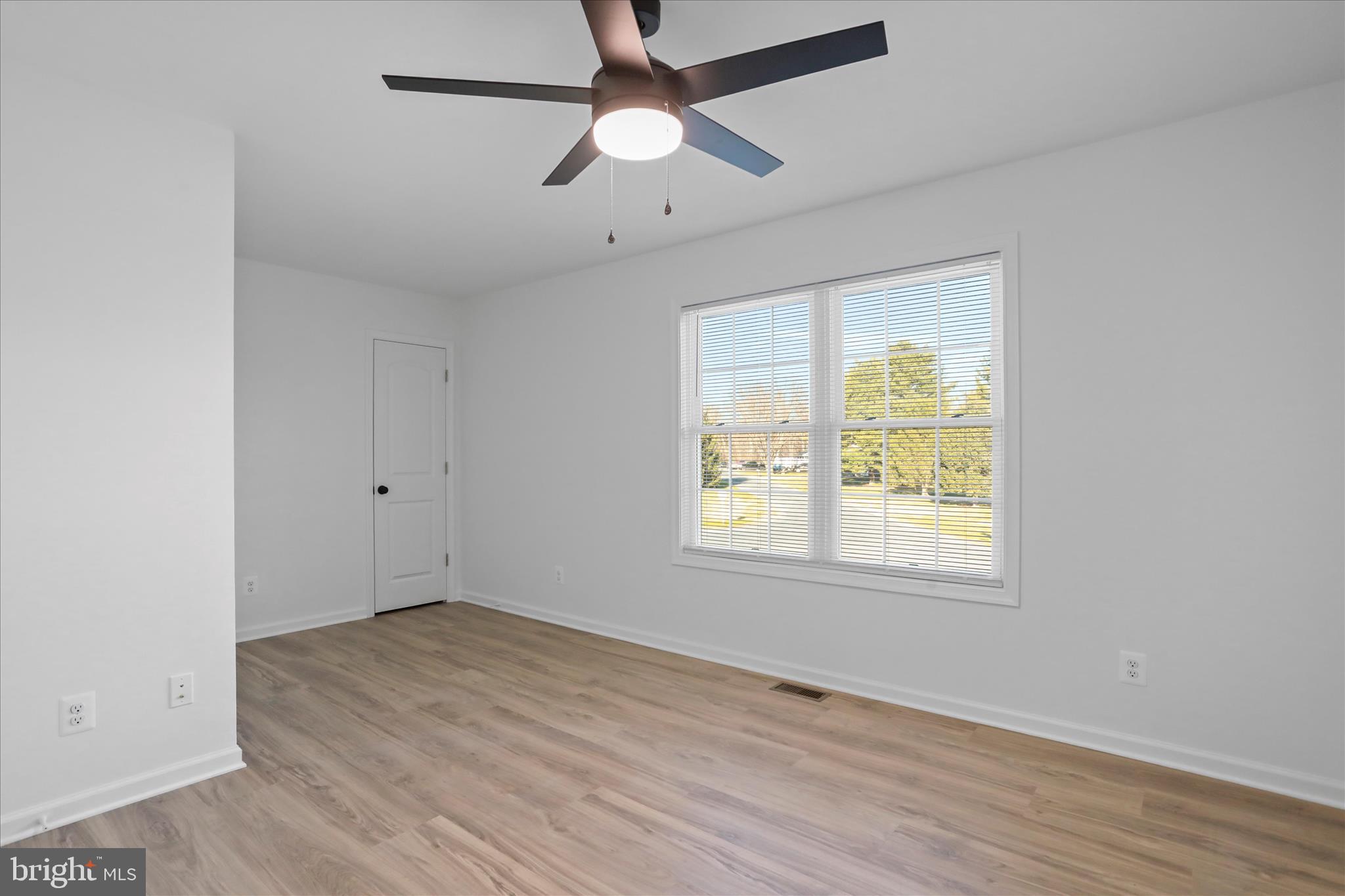 118 Windsor Knit Road Edinburg, VA 22824 - Photo 21 of 34 an empty room with wooden floor ceiling fan and windows