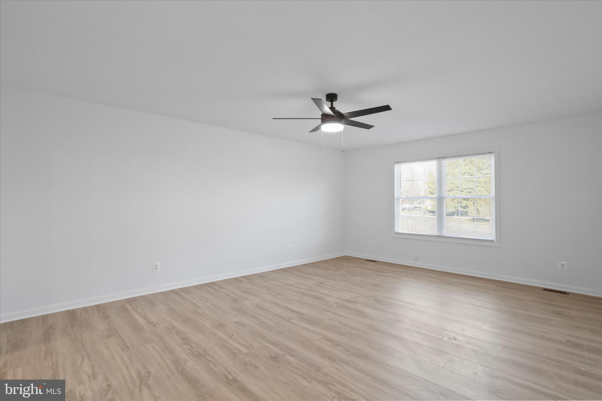 118 Windsor Knit Road Edinburg, VA 22824 - Photo 26 of 34 an empty room with wooden floor chandelier fan and windows