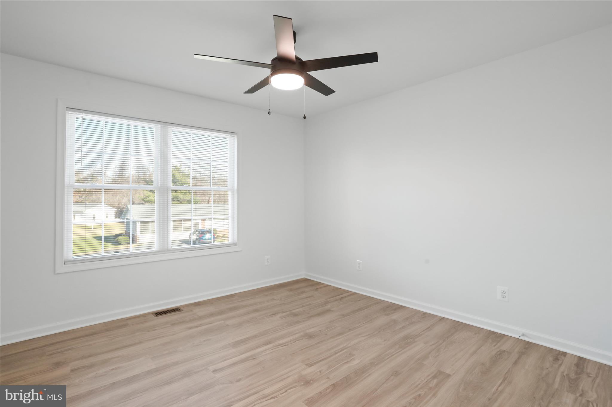 118 Windsor Knit Road Edinburg, VA 22824 - Photo 33 of 34 an empty room with wooden floor fan and windows