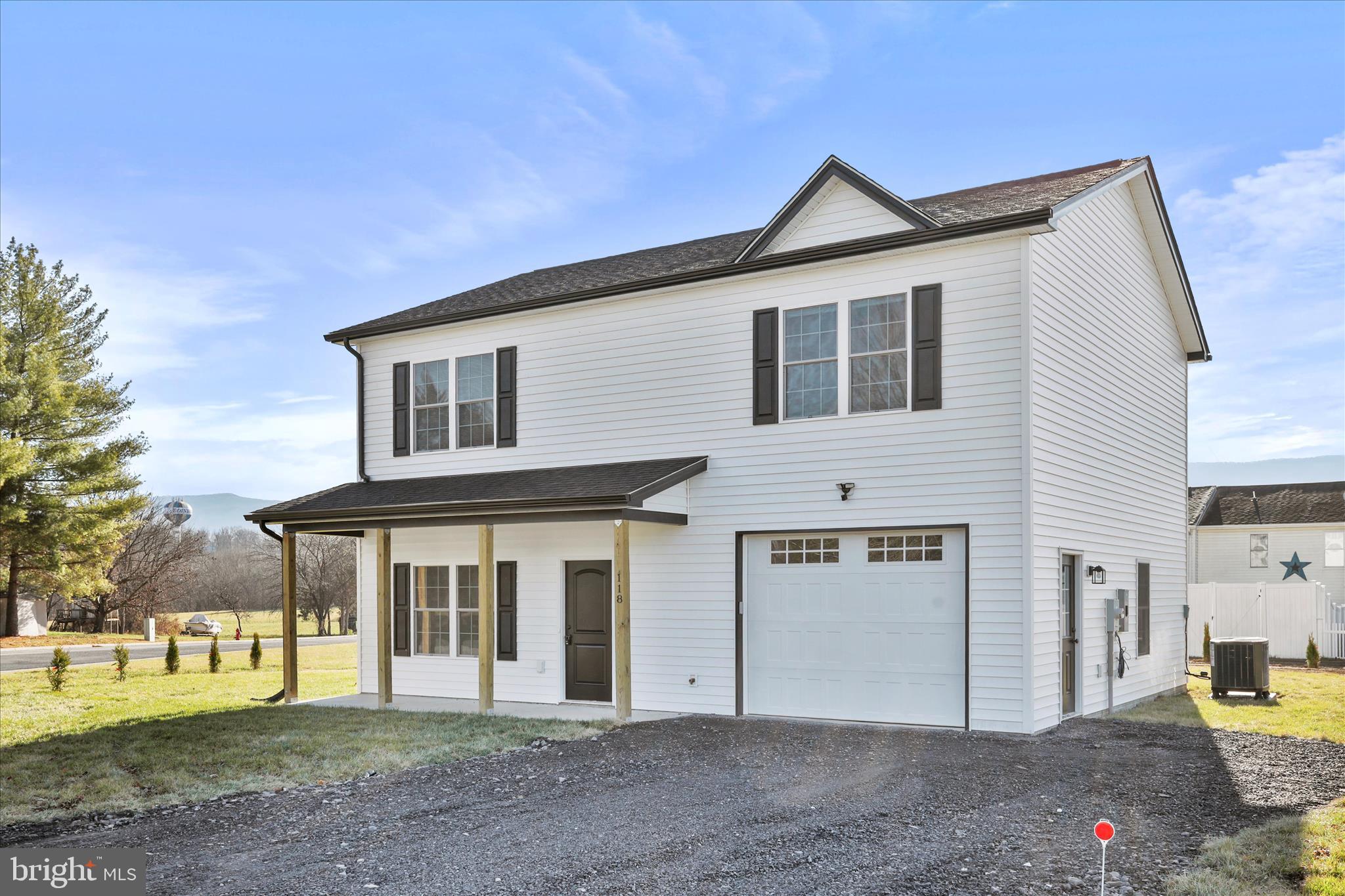 118 Windsor Knit Road Edinburg, VA 22824 - Photo 4 of 34 a front view of a house with a yard and trees
