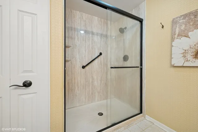 a bathroom with a glass shower door