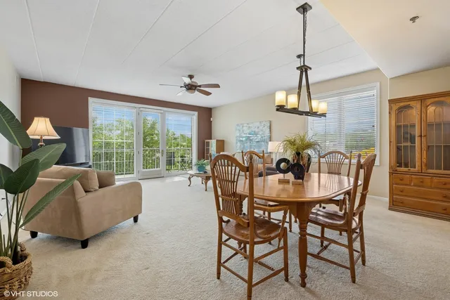 a dining room with furniture a chandelier and window