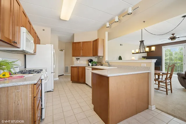 a kitchen with a stove a refrigerator and a sink