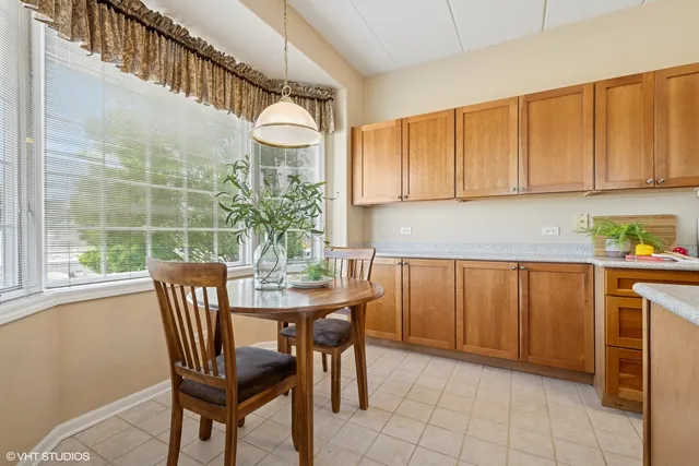 a view of a dining room with furniture and a window