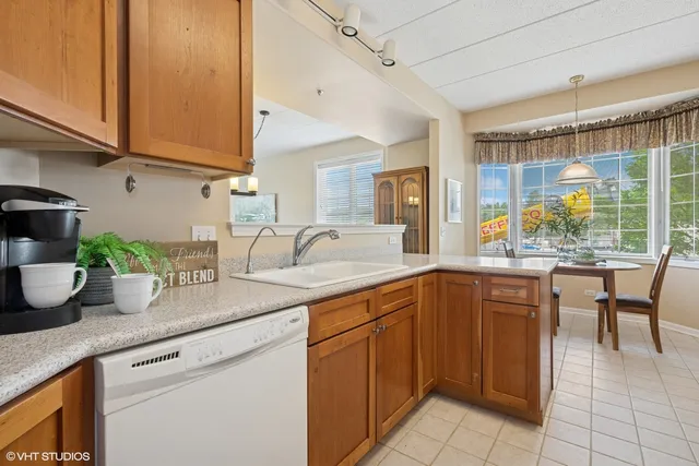 a kitchen with sink and wooden cabinets