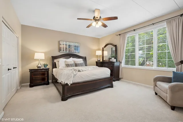 a spacious bedroom with a bed couch and a large window
