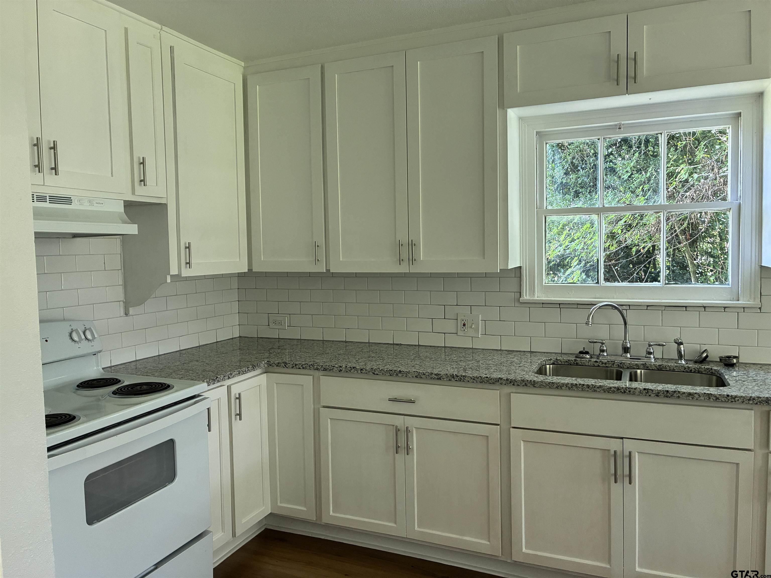 811 West 5th Street Tyler, TX 75701 - Photo 8 of 26 a kitchen with stainless steel appliances white cabinets and a sink