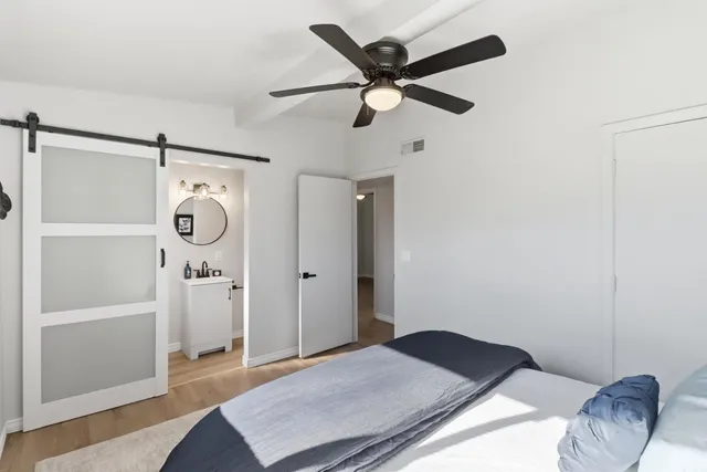 a bedroom with a bed and a mirror