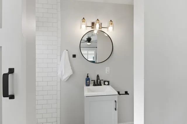a bathroom with a sink and a mirror