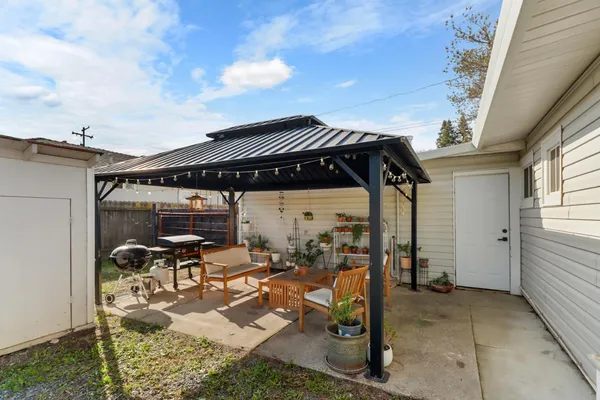 a roof deck with table and chairs