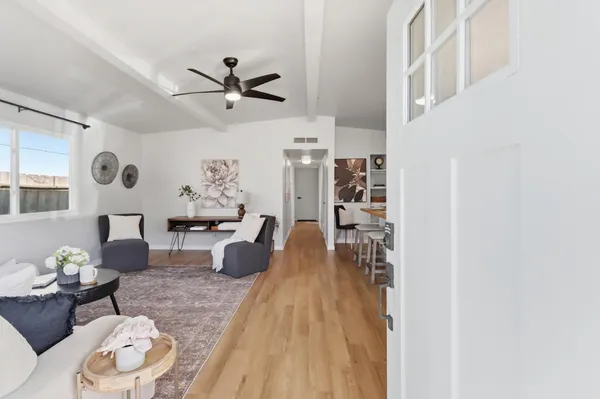 a living room with furniture and a wooden floor