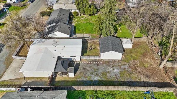an aerial view of residential houses with outdoor space and river