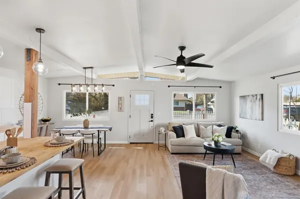 a living room with furniture and a wooden floor