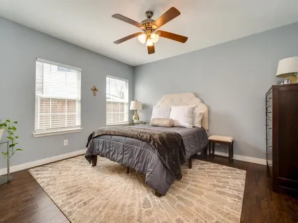 a bedroom with a bed and a chandelier