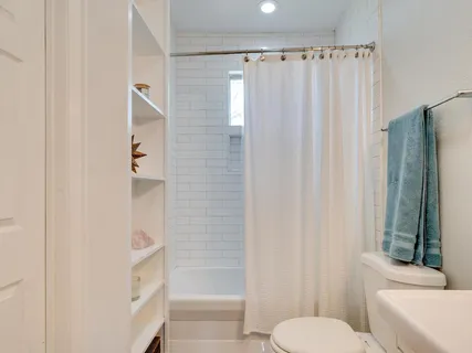 a bathroom with a toilet and a shower