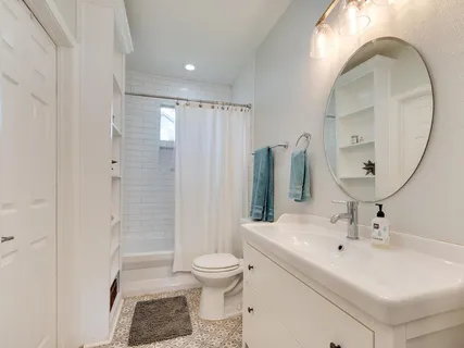 a bathroom with a sink toilet and shower