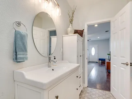 a en suite bathroom with a sink and a mirror