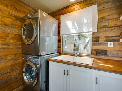 a utility room with sink dryer and washer