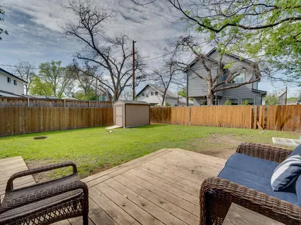 a view of a backyard with wooden fence