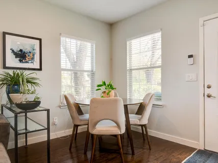 a dining room with furniture and window