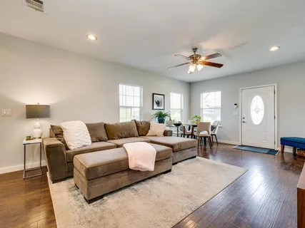 a living room with furniture a lamp and a window