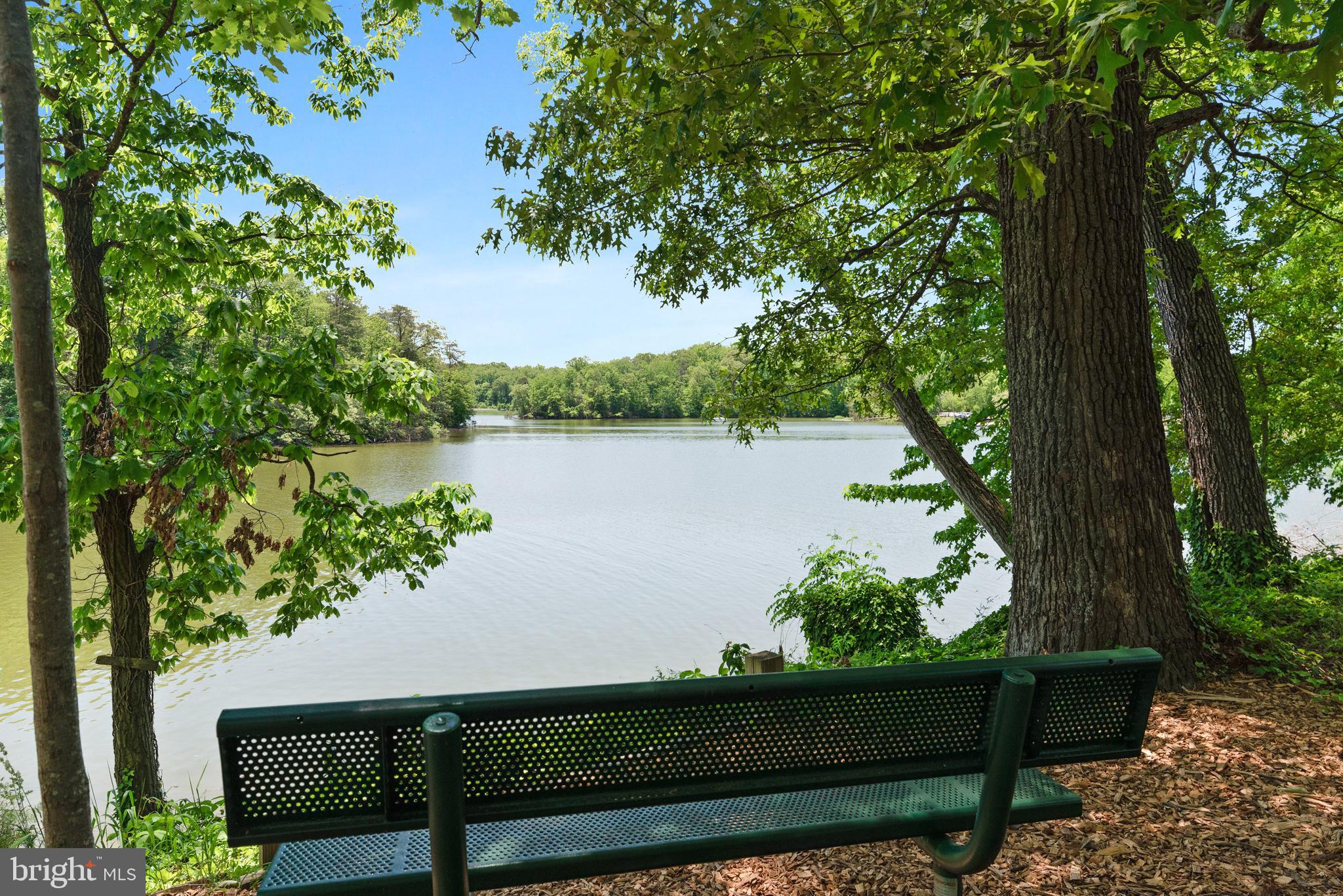 1505 Grange Road Edgewater, MD 21037 - Photo 17 of 45 a view of a wooden bench and lake