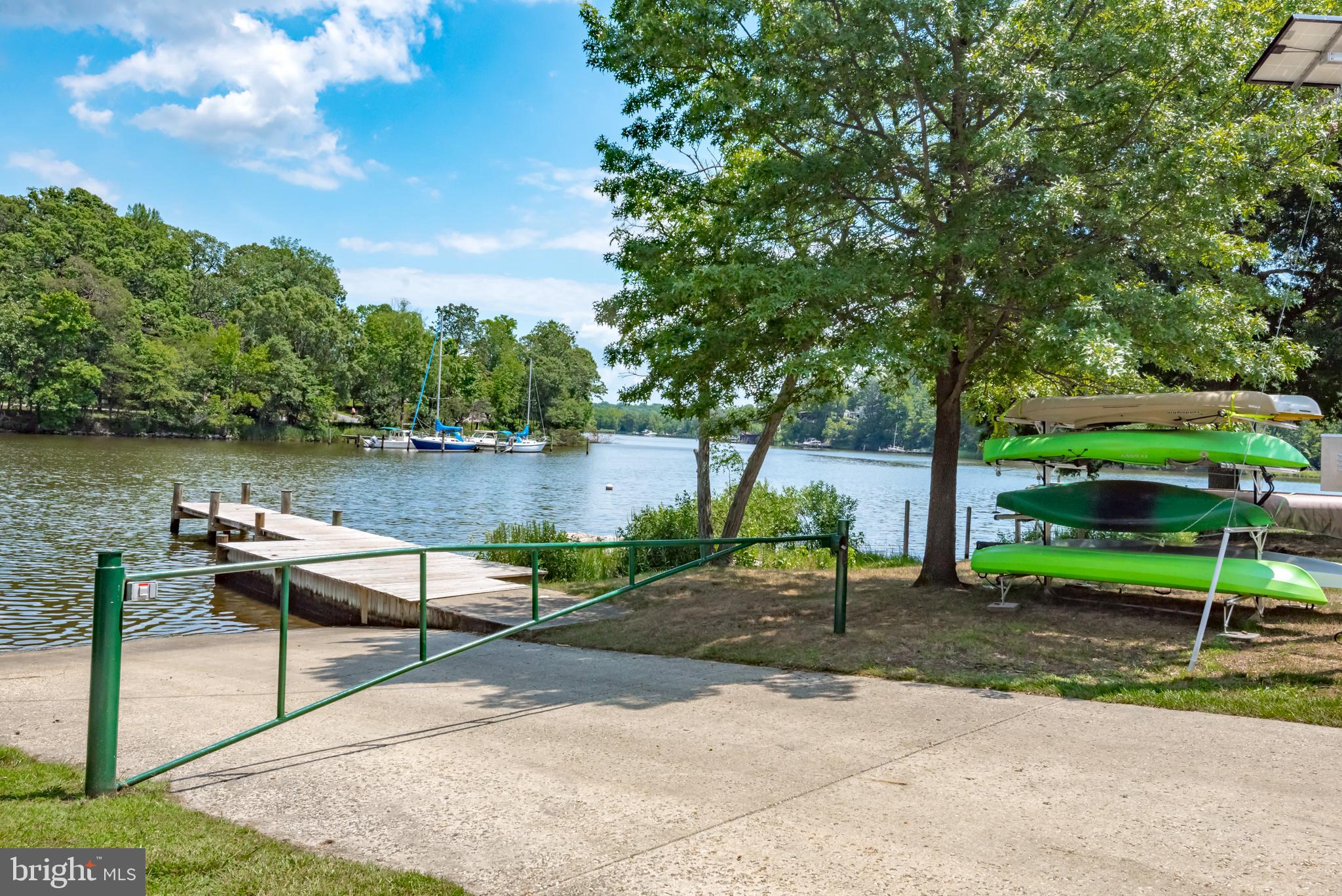 1505 Grange Road Edgewater, MD 21037 - Photo 30 of 45 a view of a lake with a bench and trees