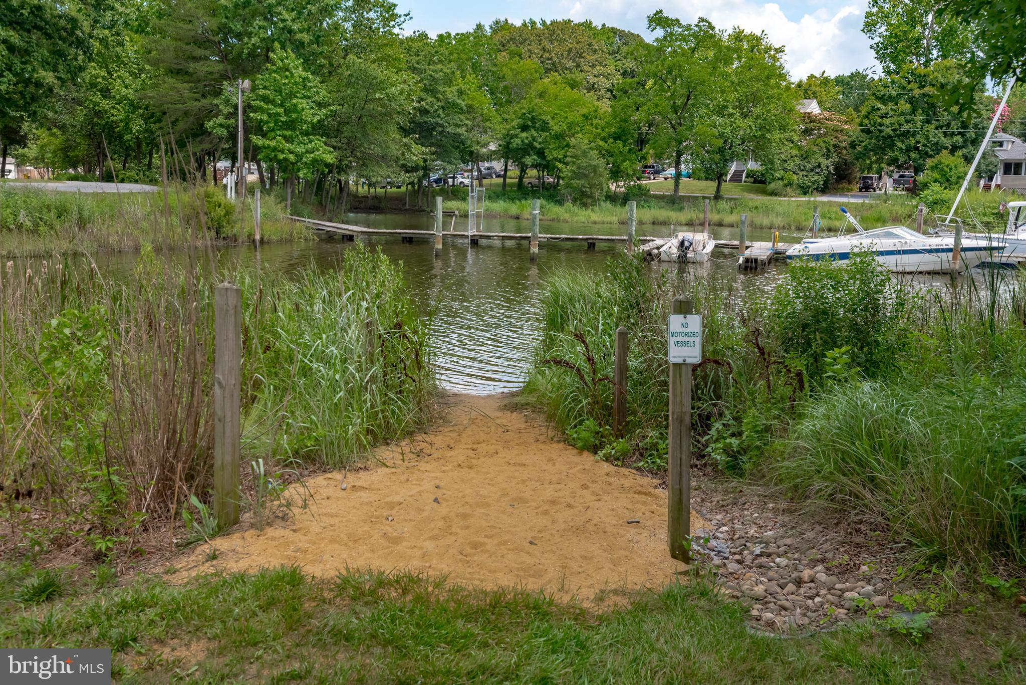 1505 Grange Road Edgewater, MD 21037 - Photo 35 of 45 a view of a lake with a yard and large trees