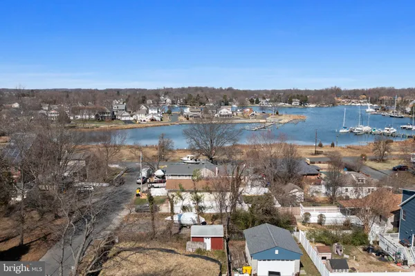 a view of an ocean with boats and trees in the background