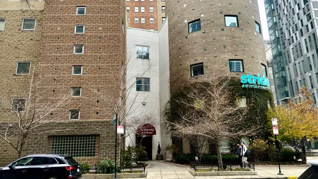 a front view of a building with parking space