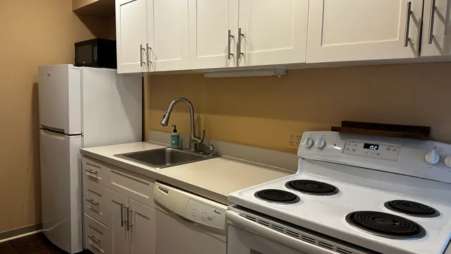 a kitchen with a sink and a refrigerator