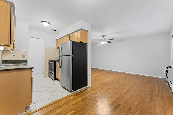 a kitchen with granite countertop a refrigerator and a sink